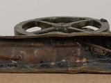 a bronze statue of a wheel on a table