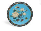 an image of a blue plate with flowers and butterflies on it