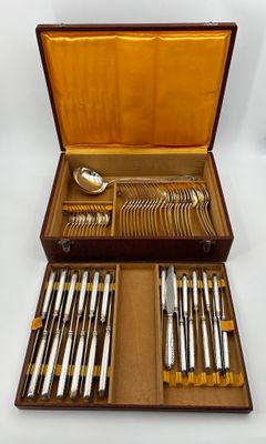 un coffret en bois contenant de l'argenterie sur une surface blanche