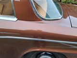 a picture of a brown car parked on the side of the road