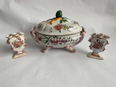 three pieces of pottery sitting on a white surface