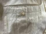 a close up of a white shirt with a button on it