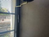 the lamp is on in the corner of the room next to the window