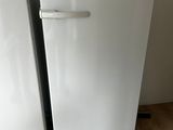two white refrigerators sitting next to each other on the floor