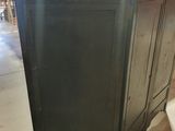 a black cabinet in the middle of a room