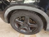 a close up of a tire on a car in a garage
