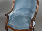 a blue chair with a wooden frame and a blue upholstered seat