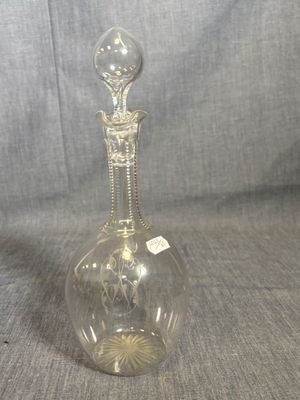 an image of a clear glass decanter on a gray background