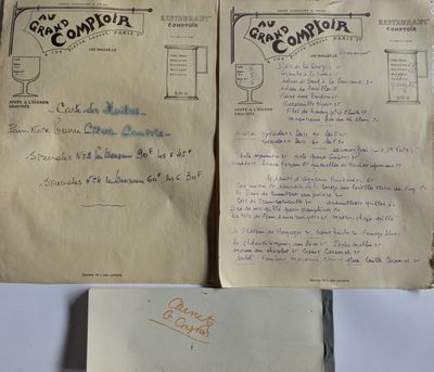 an old book with a handwritten page on it sitting on top of a table