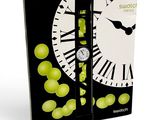 a box with a clock and a bunch of grapes on it