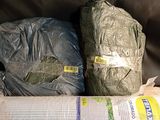 two bags of food and a roll of plastic on the floor