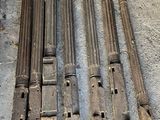 four old wooden pipes sitting on the floor next to a coin