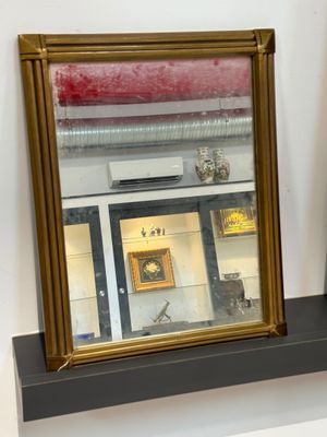 two mirrors on a shelf in front of a window