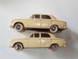 two toy cars sitting on top of each other on a table