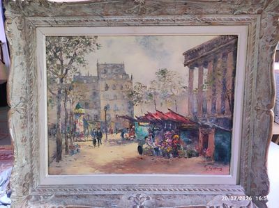 une photo d'un tableau représentant une scène de rue, dans un cadre