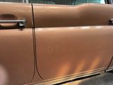 an image of a brown car parked in a parking lot