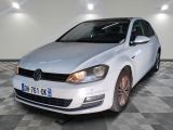 the white volkswagen golf is parked in a room with checkered floor