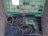 a green box with tools in it sitting on the floor