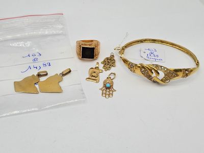 two gold bracelets, a ring, and a ring with a black stone