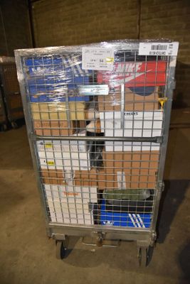 a metal cart with many boxes on it in a warehouse