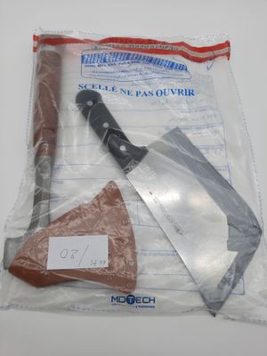 a plastic bag with a knife and a piece of meat in it