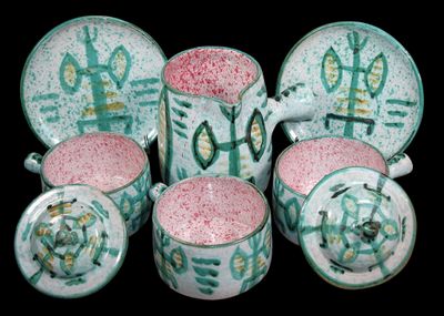 a group of cups and saucers with designs on them