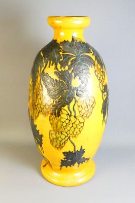 un vase jaune orné d'un motif noir et jaune