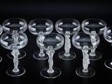six empty wine glasses are lined up in a row on a black surface
