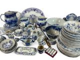a large collection of blue and white dishes and cups