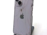 a broken iphone sitting on a stand with a broken screen