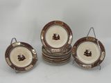 six pieces of brown and white dinner plates on a white table