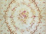 an antique rug with a floral design on a black background