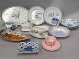 many plates and cups and saucers sitting on a table