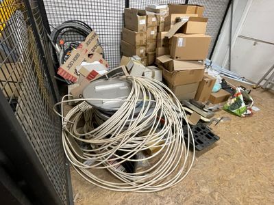 a pile of wires and boxes in a room