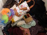 a pile of clothes and a bag on the floor