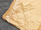 a close up of a yellow blanket on the ground