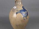 a brown vase with a blue bird on it