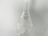 clear glass bottle with a silver top on a white surface