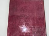 a red book on a white table with a white background