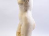 marble statue of a woman sitting on a wooden base