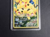 the pokemon card is in a plastic case on a black surface