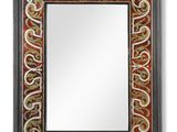 a black and red mirror with a decorative design on it