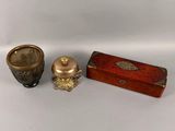 three different types of brass and wood items on a white surface