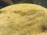an image of a close up of a wooden table with a circular design on it
