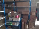many boxes and boxes stacked on a shelf in a warehouse