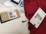 a red hoodie on top of a pile of clothes