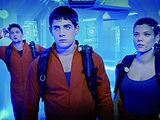 two people standing in front of a sci - fiction scene with a spaceship in the background