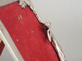 a picture of a silver ring on a red cloth