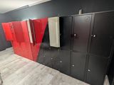 many lockers in the room with red doors