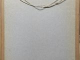 an old picture frame with a string hanging from it ' s side
